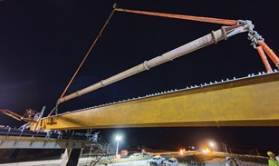 The girders arrived on-site by 7am where a crane unloaded each girder and lifted it into place.